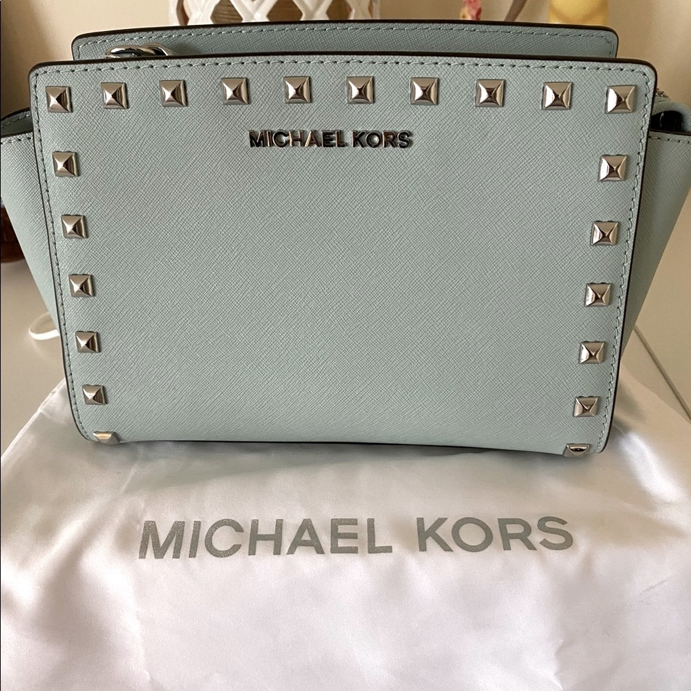 Michael Kors ready for spring sea foam in color purse with shoulder strap.